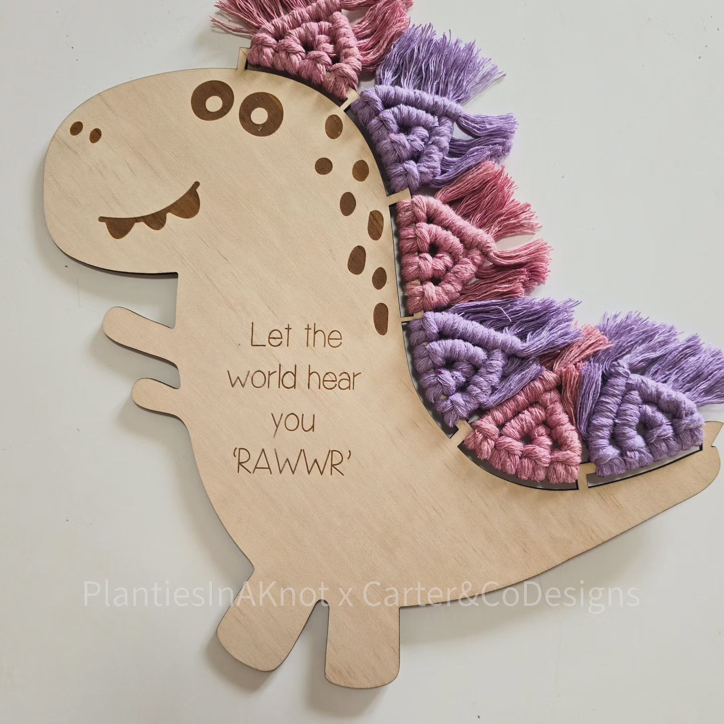 Macrame Dinosaur. Laser Engraved. Personalised. Made with Carter & Co Designs. Dusty Rose & Purple
